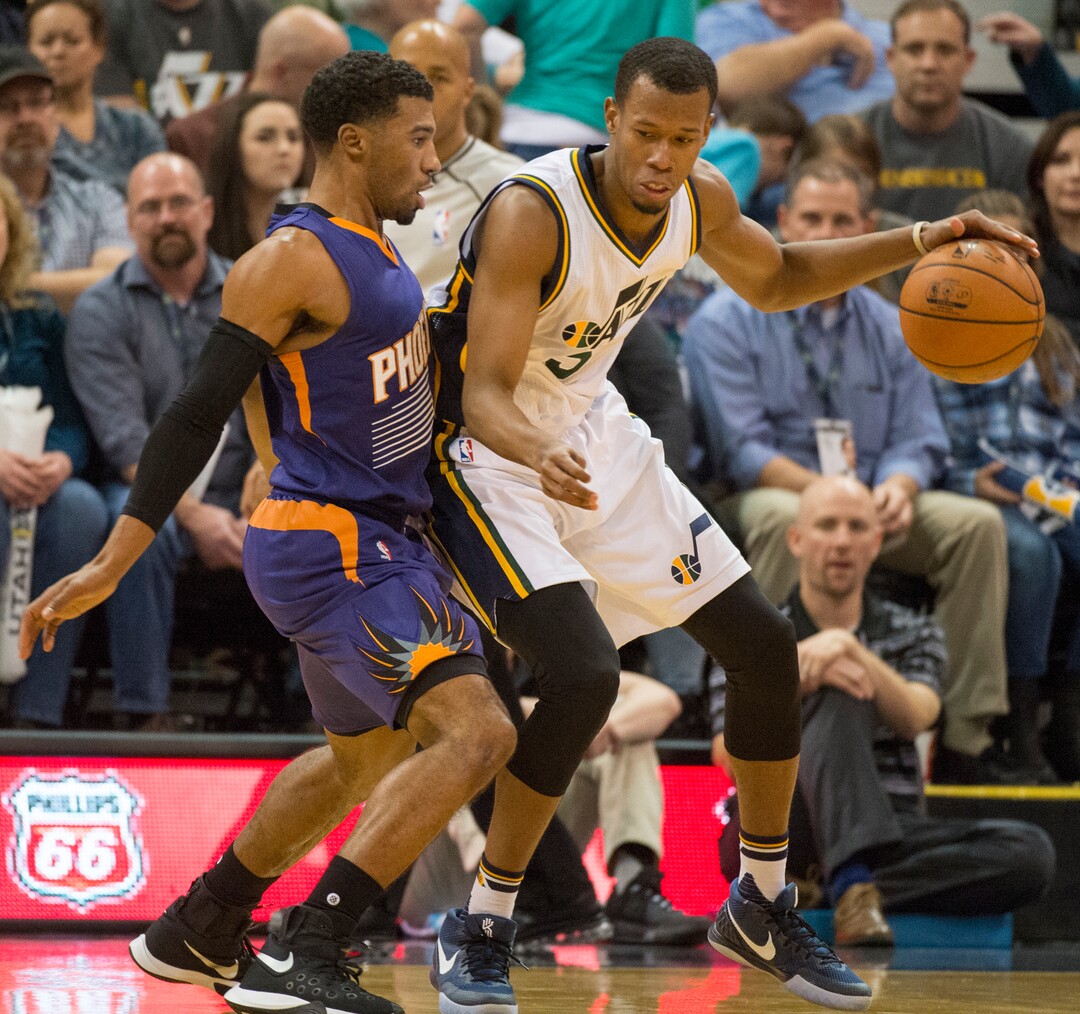 Rick Egan  |  The Salt Lake TribuneUtah Jazz guard Rodney Hood (5) tries to work the ball inside, as Phoenix Suns guard Ronnie Price (14) defends, in NBA action Phoenix Suns vs. The Utah Jazz, in Salt Lake City, Monday, December 21, 2015.
