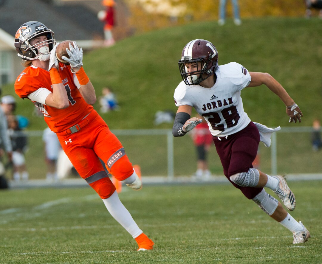 (Rick Egan  |  The Salt Lake Tribune)   Skyridge wide reciever Dylan Samuels catches a pass as Jordan High defensive back Alex Harston defends, in prep 5A playoff action, in Lehi, Friday, Nov. 2, 2018.