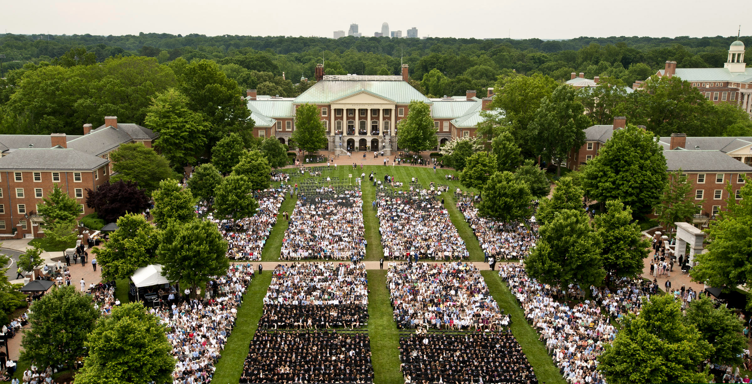 This May 21, 2018 photo shows the Wake Forest University commencement on Hearn Plaza, in Winston-Salem, N.C. Dozens of people were charged Tuesday, March 12, 2019, in a scheme in which wealthy parents allegedly bribed college coaches and other insiders to get their children into some of the nation's most elite schools. The coaches worked at such schools as Wake Forest, Yale, Stanford, Georgetown, the University of Texas, the University of Southern California and the University of California, Los Angeles. (Walt Unks/The Winston-Salem Journal via AP)
