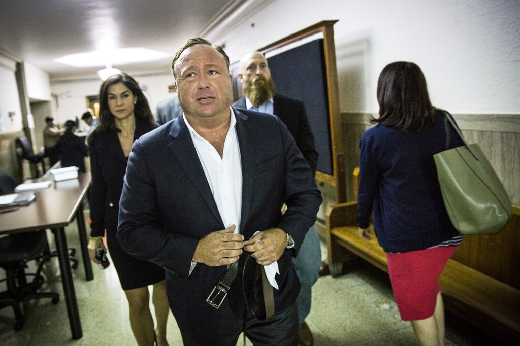 In this April 17, 2017, file photo, "Infowars" host Alex Jones arrives at the Travis County Courthouse in Austin, Texas. Infowars, a website that suggested survivors of the Florida school shooting were coached on their pleas for gun control, says its video account was temporarily frozen by YouTube. (Tamir Kalifa/Austin American-Statesman via AP, File)