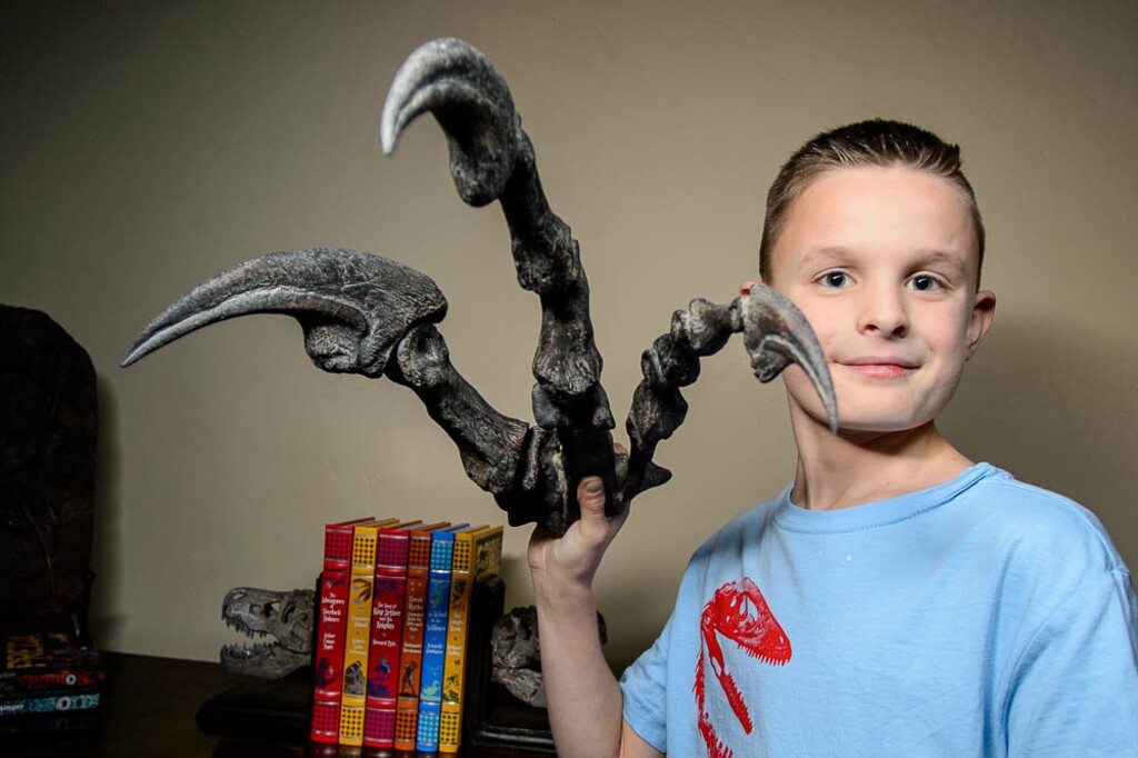 (Trent Nelson | The Salt Lake Tribune)  10-year-old dinosaur fanatic Kenyon Roberts holds a model of an Allosaurus claw in his dinosaur-themed room, Thursday December 14, 2017 in Draper. Roberts persuaded Sen. Curt Bramble to draft legislation to change Utah state fossil from Allosaurus to Utahraptor.
