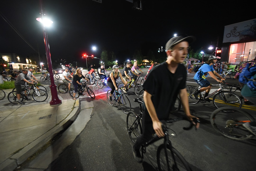 (Francisco Kjolseth  |  The Salt Lake Tribune)  A large group of cyclist begins their ride from the corner of 9th and 9th after gathering after 9pm in Salt Lake City on Thursday, July 26, 2018, for the weekly ride that has become known as the 999 Ride. The inclusive, all-welcoming slow casual social ride happens year round on Thursday nights, with riders often pedaling into the early morning hours. Newly released video shows rider Cameron Hooyer being struck and killed by a FrontRunner train at a downtown railroad crossing during last weeks ride when the 22-year-old failed to stop or heed the warning signals before crossing the tracks during the group ride. 