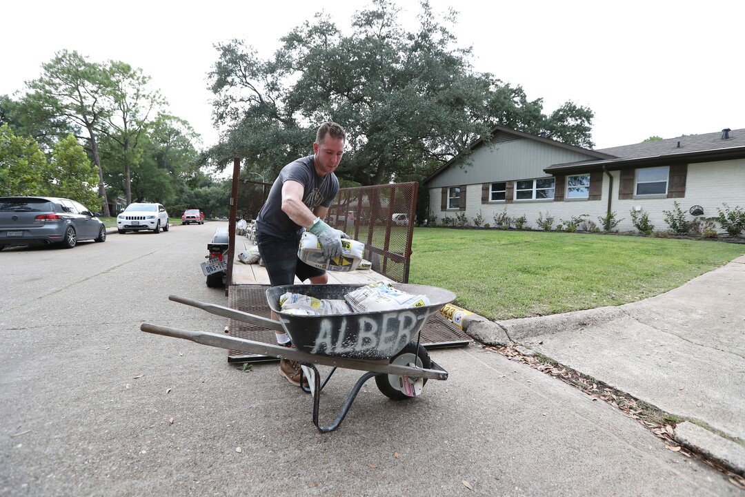 (Steve Gonzales | Houston Chronicle)  Grant Gaffney unloads sandbags from a flatbed Thursday, Aug. 24, 2017, in Houston. Tropical Storm Harvey intensified Thursday into a hurricane that forecasters said would be the first major hurricane to hit Texas in 12 years.