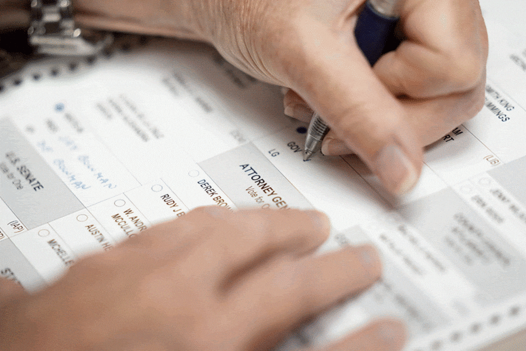(Bethany Baker | The Salt Lake Tribune) An observer writes in candidate names on a test ballot during a “logic and accuracy” test, as required by the state before every major election, at Salt Lake County Government Center in Salt Lake City on Friday, Oct. 11, 2024.