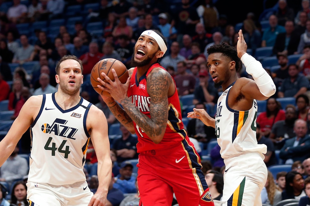 New Orleans Pelicans forward Brandon Ingram drives to the basket between Utah Jazz forward Bojan Bogdanovic (44) and guard Donovan Mitchell during the first half of an NBA basketball game in New Orleans, Thursday, Jan. 16, 2020. (AP Photo/Gerald Herbert)