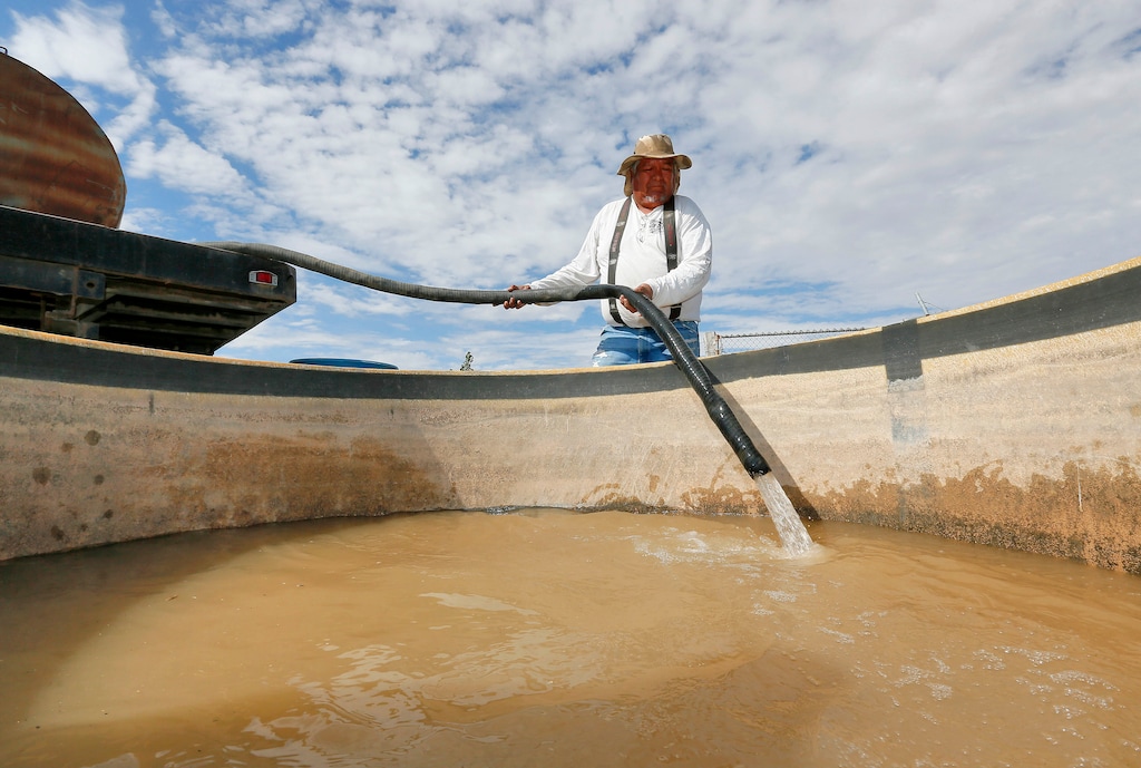 (Matt York | The Associated Press) Richard Charley delivers water to a ranch along the San Juan River on the Navajo Reservation, Wednesday, Aug. 12, 2015, in Shiprock, NM. Toxic wastewater from the Gold King Mine in Silverton, Colo., has contaminated the San Juan River in Northern New Mexico from the runoff of the Animas River due to an accidental breach by a mining a safety team working for the Environmental Protection Agency last week. A 100-mile-long plume has since traveled for hundreds of miles, through parts of Colorado, New Mexico and Utah on the way to Lake Powell, a key source of water for the Southwest.