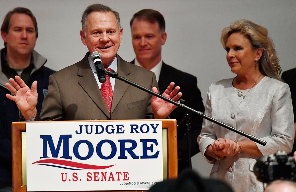 (AP Photo/Mike Stewart) U.S. Senate candidate Roy Moore speaks as his wife, Kayla Moore, right, listens at the RSA activity center, Tuesday, Dec. 12, 2017, in Montgomery, Ala. Moore did not concede to his Democratic opponent Doug Jones.