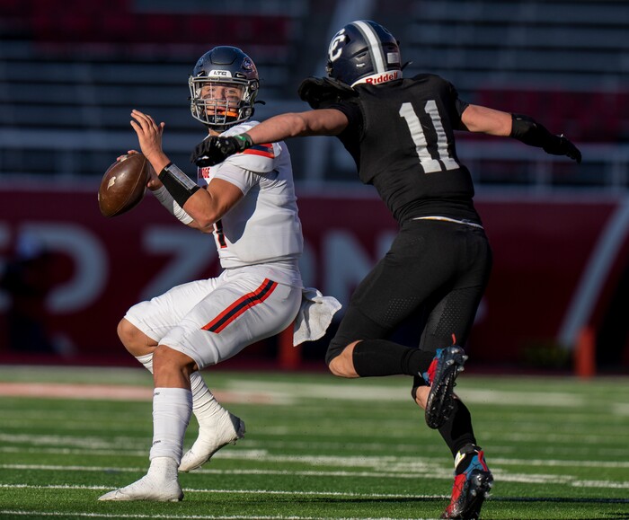 (Rick Egan | The Salt Lake Tribune)  Corner Canyon Defensive End Sam Chandler puts pressure on Skyridge QB Jackson Stevens, in 6A State playoff action between the Corner Canyon Chargers and the Skyridge Falcons, at Rice-Eccles Stadium, on Friday, Nov. 17, 2023.