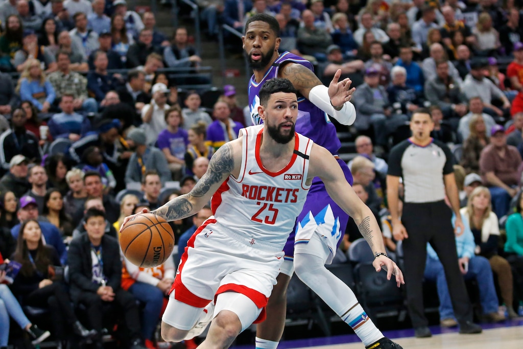 Houston Rockets guard Austin Rivers (25) drives around Utah Jazz forward Royce O'Neale, rear, in the first half during an NBA basketball game Monday, Jan. 27, 2020, in Salt lake City. (AP Photo/Rick Bowmer)