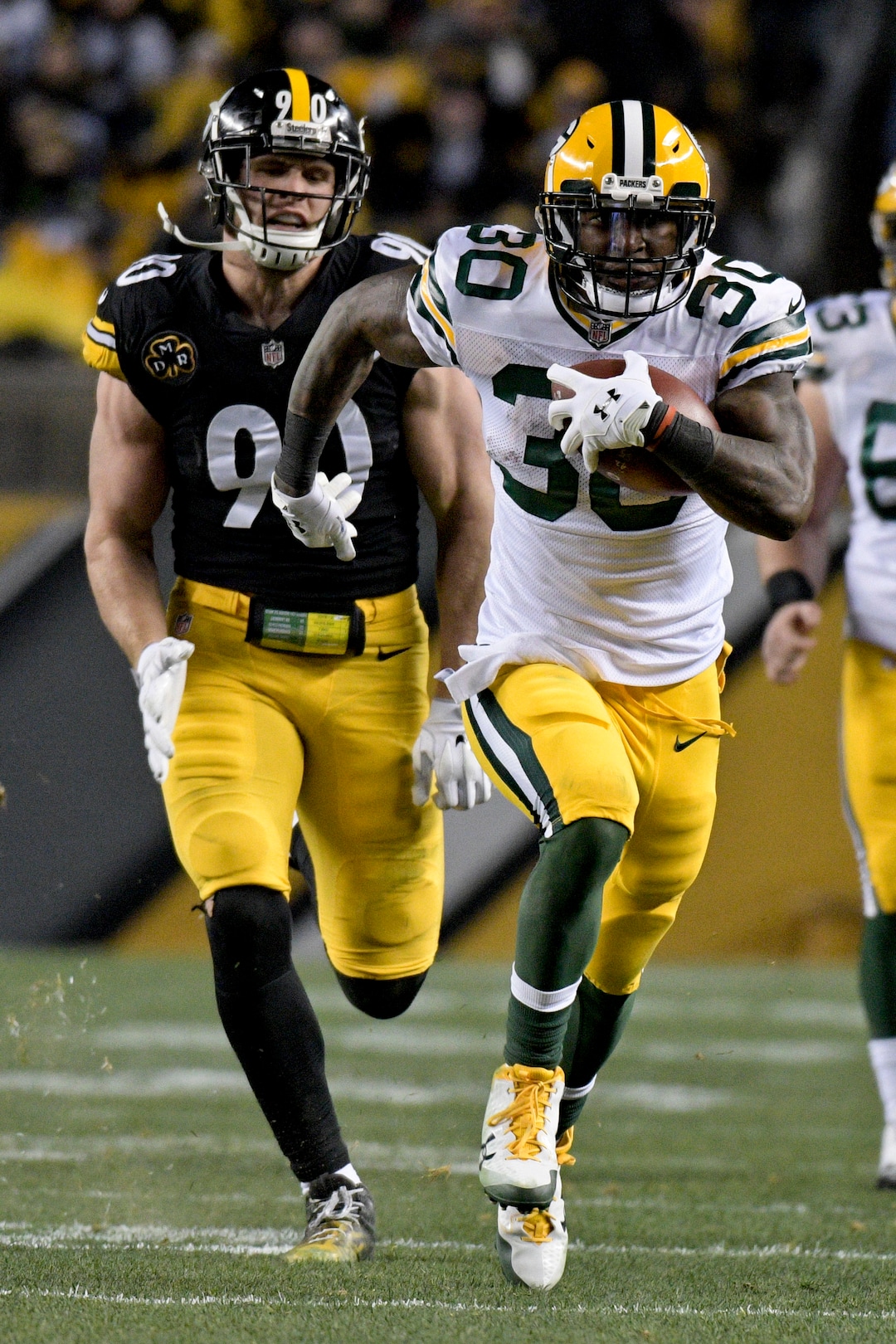 Green Bay Packers running back Jamaal Williams (30) runs through the defense for a touchdown as he plays in an NFL football game against the Pittsburgh Steelers, Sunday, Nov. 26, 2017, in Pittsburgh. (AP Photo/Don Wright)
