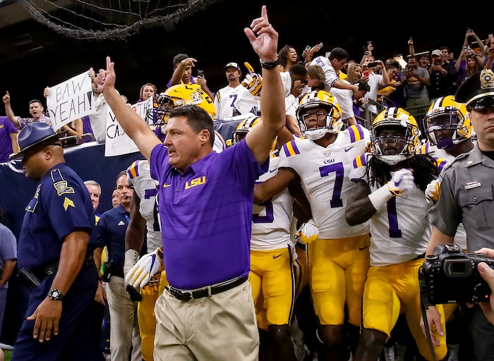 LSU head coach Ed Orgeron leads his team onto the field against BYU in the first half of an NCAA college football game in New Orleans, Saturday, Sept. 2, 2017. (AP Photo/Scott Threlkeld)