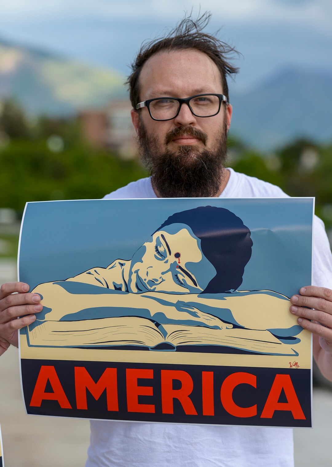 (Leah Hogsten  |  The Salt Lake Tribune) "I'm tired of the violence, especially toward kids," said Wally McGovern who holds a freshly printed poster he designed and had made Friday, May 18, 2018 after the 22nd school shooting of 2018.  Members of March For Our Lives SLC members and concerned citizens gather at the Utah Capitol,  to demand gun reform and honor the 10 dead who were killed during Friday morning's shooting spree inside Santa Fe High School in southeast Texas.