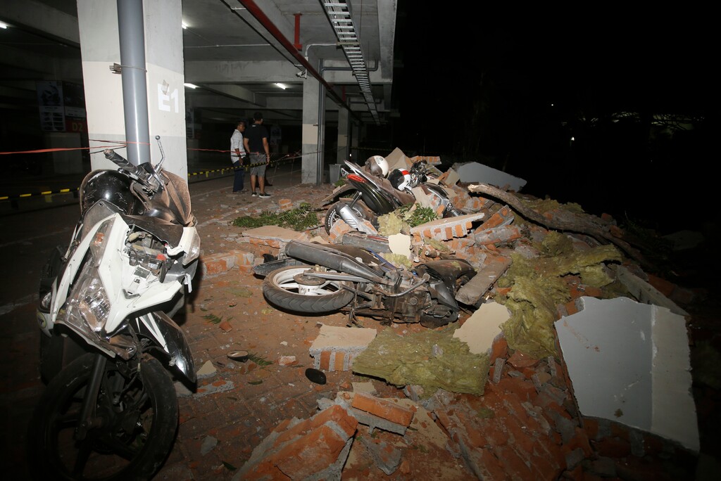 Debris on top of a motorcycles after an earthquake in Bali, Indonesia, Sunday, Aug. 5, 2018. A strong earthquake struck the Indonesian tourist island of Lombok on Sunday, killing at least three people and shaking neighboring Bali, one week after another quake on Lombok killed more than a dozen. (AP Photo/Firdia Lisnawati)