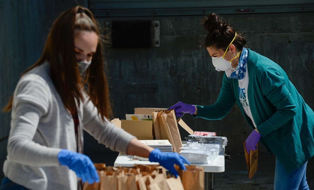 (Francisco Kjolseth  |  The Salt Lake Tribune) The UMFA learning engagement team members Katie Seastrand, left, and Annie Burbidge Ream assemble "UMFA Art Kits," to provide art supplies to high school students to help them complete end-of-year course work. The volunteers filled 1,500 kits with colored pencils, postcards and art activities on Friday, May 4, 2020, to help kids in the Granite School District and Whitehorse High School in San Juan County, to finish school projects and get excited about home projects during the coronavirus pandemic.