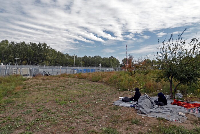 An Afghan family rest in the makeshift refugee camp at Serbia's border with Hungary, near the Horgos border crossing, Serbia, Tuesday, Sept. 19, 2017. The European Union border that saw hundreds of thousands of migrants enter freely in 2015 has since become a sealed fortress with two rows of fence and closed border camps that the United Nations have described as “in effect detention centers.” (AP Photo/Darko Vojinovic)