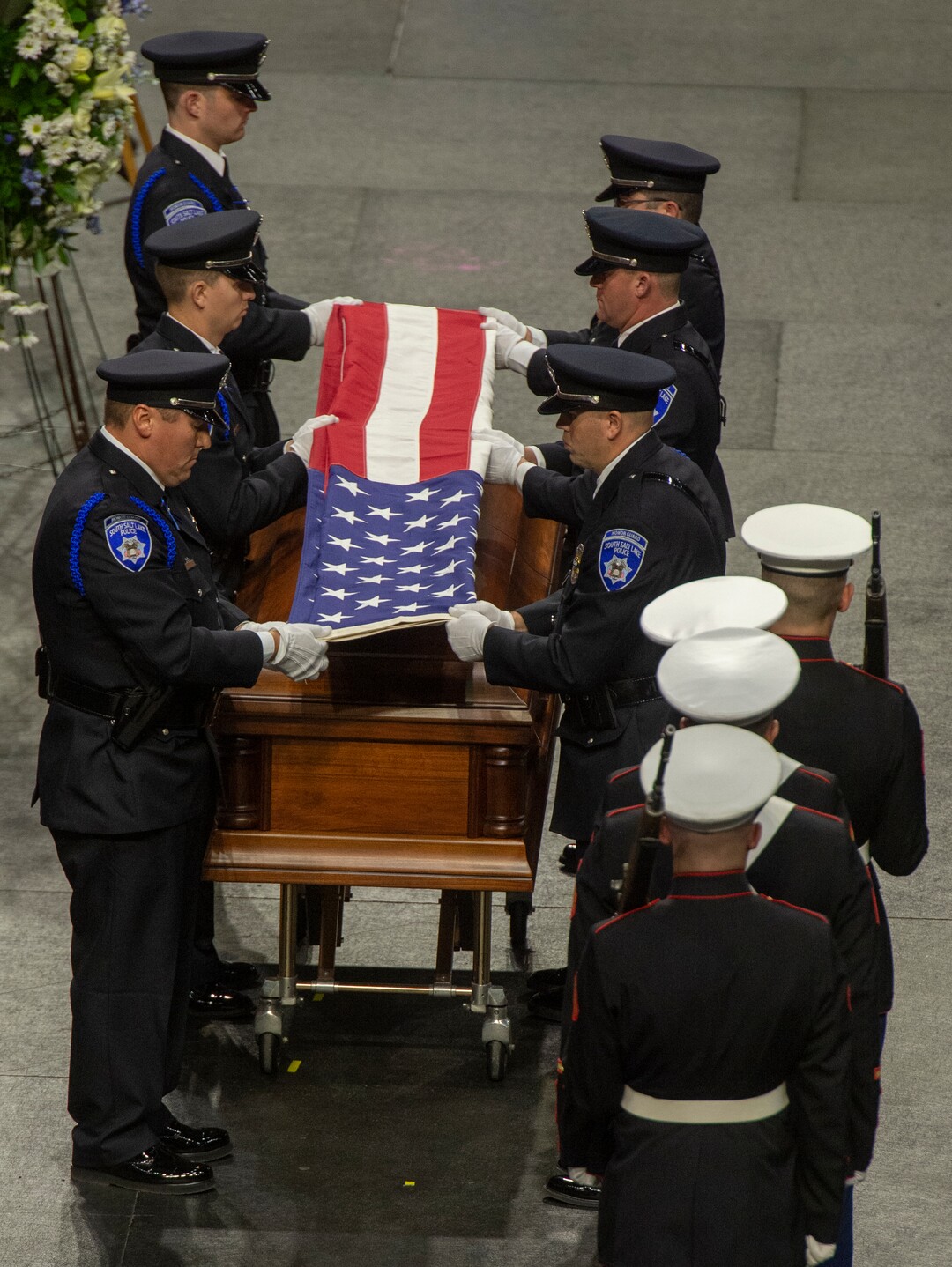 (Rick Egan  |  The Salt Lake Tribune)     The South Salt Lake Police Honor Guard folds the American flag, during the funeral for South Salt Lake police officer, David Romrell, at the Maverik Center in West Valley City, Wednesday, Dec. 5, 2018.