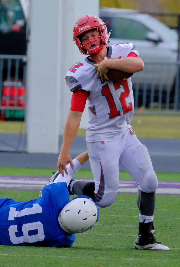 (Leah Hogsten  |  The Salt Lake Tribune) Delta's Layton Day tries to slip past Beaver's Jacob Bairett. Beaver High School boys' football team leads Delta High School 35-16 during their class 2A state semifinal football game Saturday, November 4, 2017 at Weber State University's Stewart Stadium.