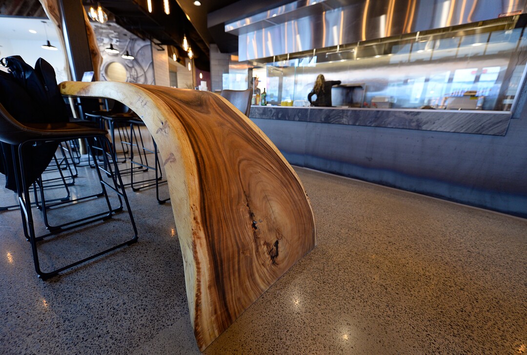 (Francisco Kjolseth  |  The Salt Lake Tribune)  Tables made from acacia wood inside HallPass.