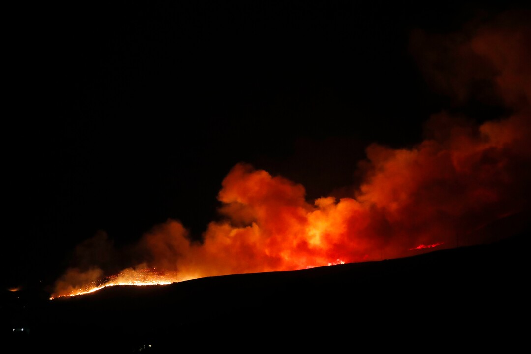 (George Frey  |  for The Salt Lake Tribune) A wildfire burns on Traverse Mountain above Lehi, Uta,h on June 28th, 2020.