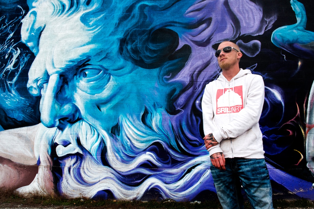 (Rick Egan  |  The Salt Lake Tribune)Shae Petersen in front of one of his murals on 300 West and 3300 South in Salt Lake City.  Petersen is a muralist trying to get a mural painted on the side of the Exotic Kitty strip club in South Salt Lake. Friday, December 15, 2017.