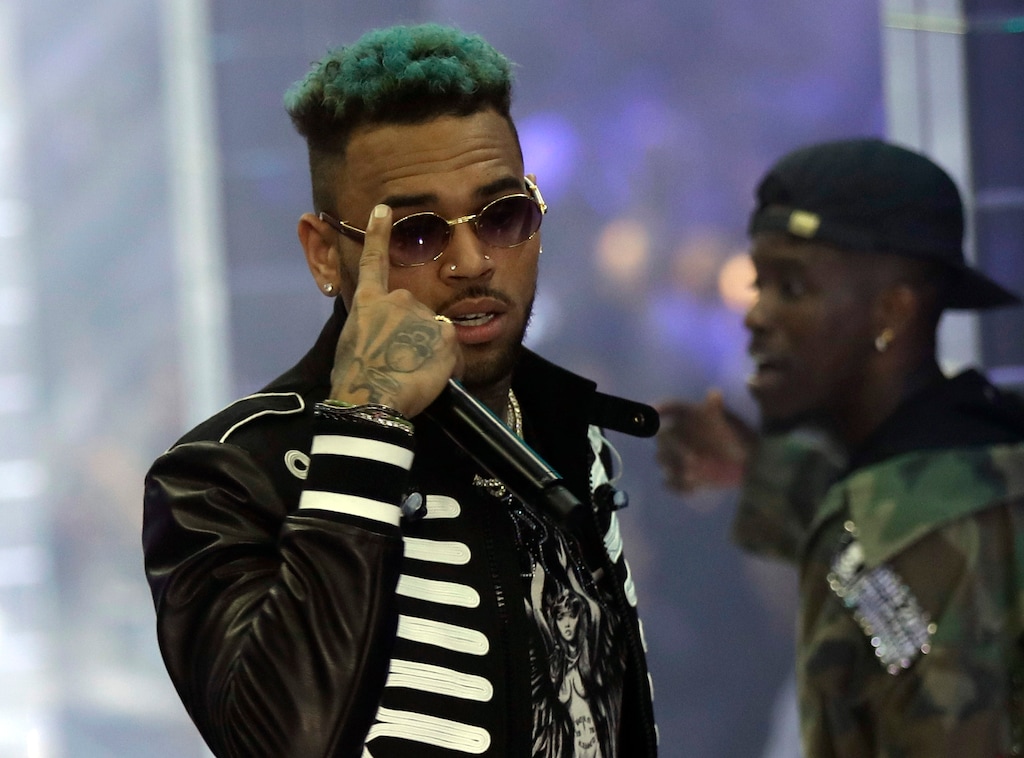 FILE - In this Sept.21, 2018 file photo, singer Chris Brown performs during Philipp Plein's women's 2019 Spring-Summer collection, unveiled during the Fashion Week in Milan, Italy. Two police officials say U.S. singer Chris Brown and two other people are in custody in Paris after a woman filed a rape complaint. (AP Photo/Luca Bruno, File)