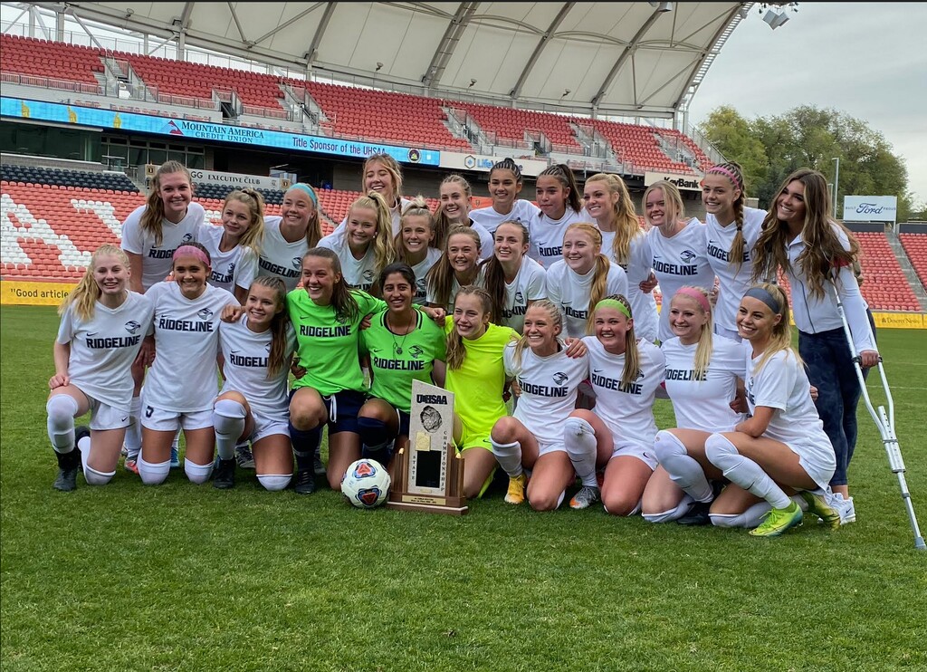 (Tribune photo by Alex Vejar) | Ridgeline girls celebrate the 4A soccer championship they won on Friday, edging Ogden 3-2 at Rio Tinto Stadium.