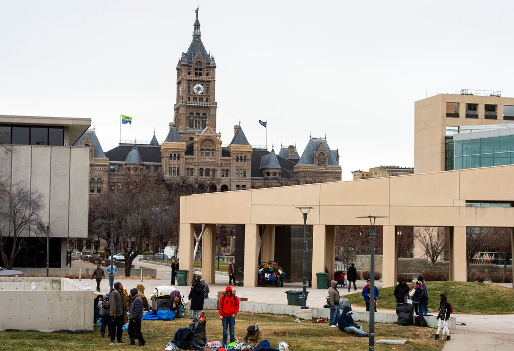 (Rick Egan | The Salt Lake Tribune) People are forced to pack up their belongings in carts and wagons near the Salt Lake City Library, Monday, Dec. 23, 2019.