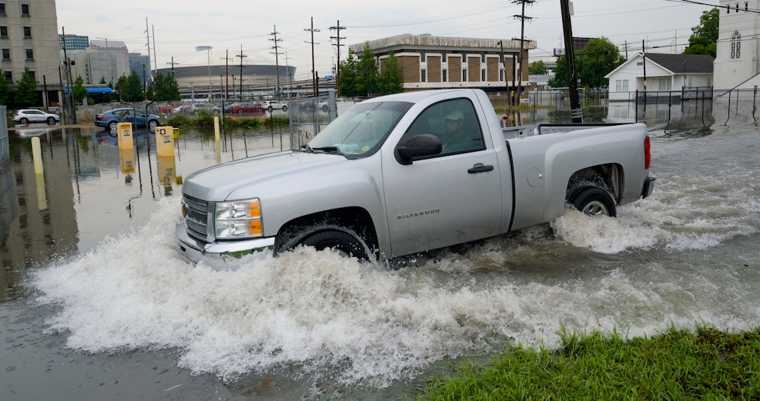 (Matthew Hinton | AP Photo) A truck passes by the University Medical Center (UMC) with the Mercedes-Benz Superdome in the background on Glavez Street in New Orleans after flooding from a storm Wednesday, July 10, 2019. Louisiana Gov. John Bel Edwards has declared a state of emergency in anticipation of tropical weather that could dump as much as 15 inches (38 centimeters) of rain in the state over the coming days.
