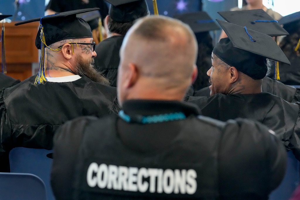 (Francisco Kjolseth | The Salt Lake Tribune) Prison inmates Dusten Anderson, left, and Albert Givens get ready to receive their high school diplomas as the Utah Department of Corrections and Salt Lake City School District host the inaugural high school graduation ceremony at the Utah State Correctional Facility on Monday, June 5, 2023.