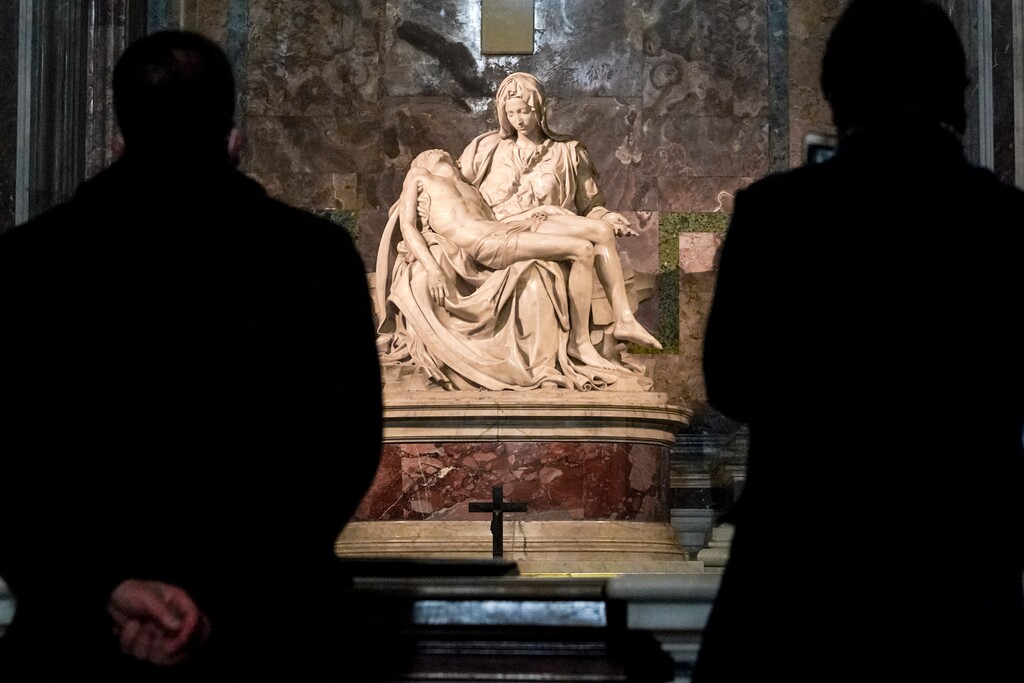 (Andrew Medichini | AP) Visitors admire Michelangelor's "The Pieta" at the Vatican. A new book explores the what is known and not known about the Virgin Mary.