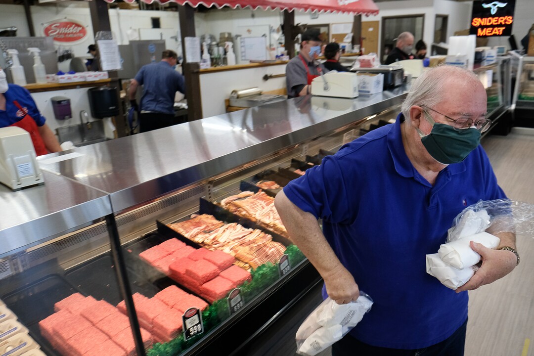 (Francisco Kjolseth  |  The Salt Lake Tribune) Customer Richard Christensen picks up an order at Snider Brothers Meats in Cottonwood Heights on Tuesday, May 5, 2020, where owners Will and Amy Wilson, have been requiring that all customers wear masks or facial coverings when they come to shop.