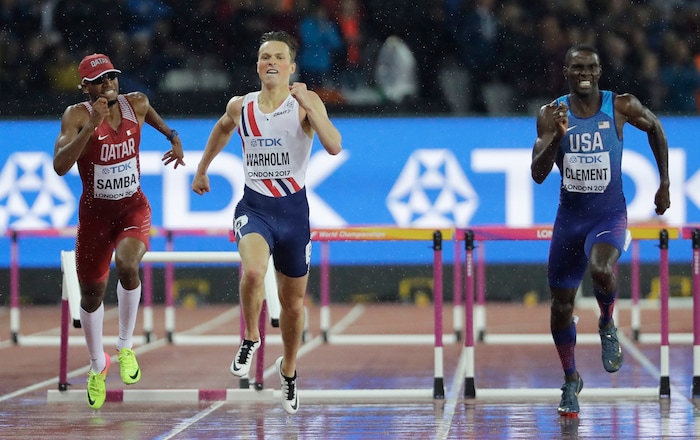 Norway's Karsten Warholm, center, races to the line ahead of United States' Kerron Clement to win the gold medal in the Men's 400m hurdles during the World Athletics Championships in London Wednesday, Aug. 9, 2017. (AP Photo/David J. Phillip)