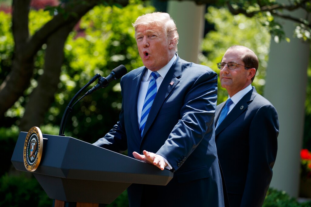 Secretary of Health and Human Services Alex Azar looks on as President Donald Trump speaks during an event about prescription drug prices in the Rose Garden of the White House, Friday, May 11, 2018, in Washington. (AP Photo/Evan Vucci)