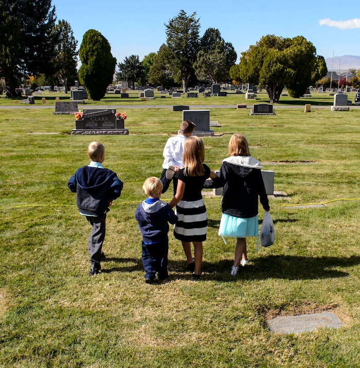 (Steve Griffin  |  The Salt Lake Tribune)  Young children explore the gravestones following graveside services for Elder Robert D Hales at the Bountiful City Cemetery in Bountiful Friday October 6, 2017.