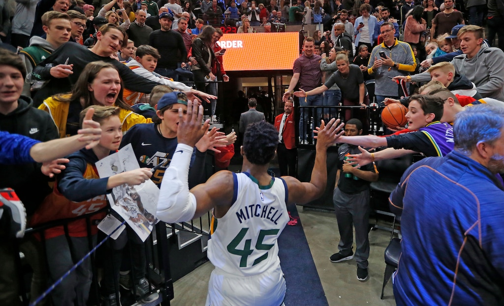 Fans reach for Utah Jazz guard Donovan Mitchell (45) following the team's NBA basketball game against the Minnesota Timberwolves on Friday, Jan. 25, 2019, in Salt Lake City. (AP Photo/Rick Bowmer)