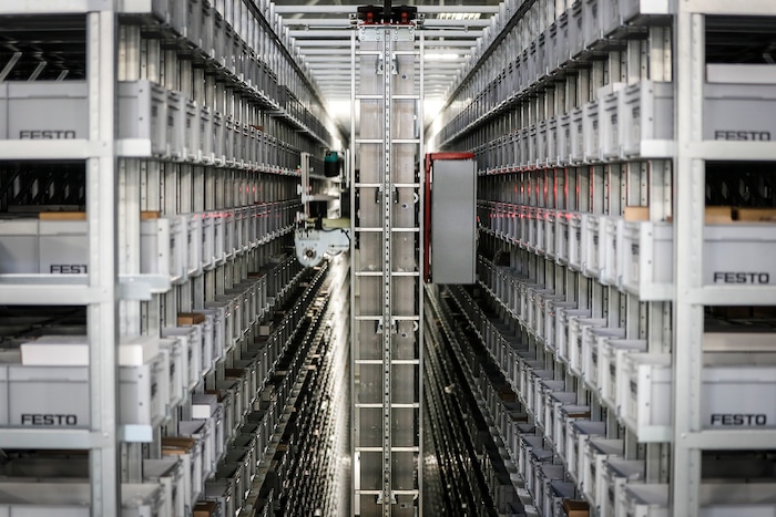 In this Wednesday, May 17, 2017 photo, a robotic conveyor uses laser guides to sort through materials storage at Festo's distribution facility in Mason, Ohio. "This kind of factory has nothing to do with the factory we knew in the 1960s or 1980 or even 2000," said Yannick Schilly, vice president for North American business for Germany-based Festo, a global industrial automation company. Floors clean and aisles uncluttered, the plant is mostly quiet as workers monitor a robotic distribution system that self-adjusts its work flow to prevent backups. (AP Photo/John Minchillo)