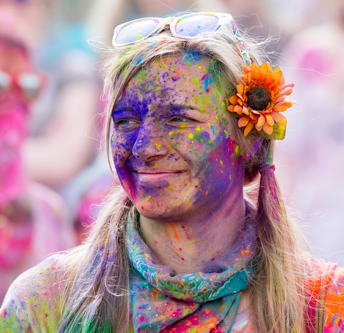 (Rick Egan  |  The Salt Lake Tribune)       Kajsa McKay, Provo, watches the entertainment, during the 22nd annual Holi Festival of Colors at the Sri Sri Radha Krishna Temple in Spanish Fork, Saturday, March 24, 2018. The festival which celebrates the beginning or spring is also known as at the Festival of Love.