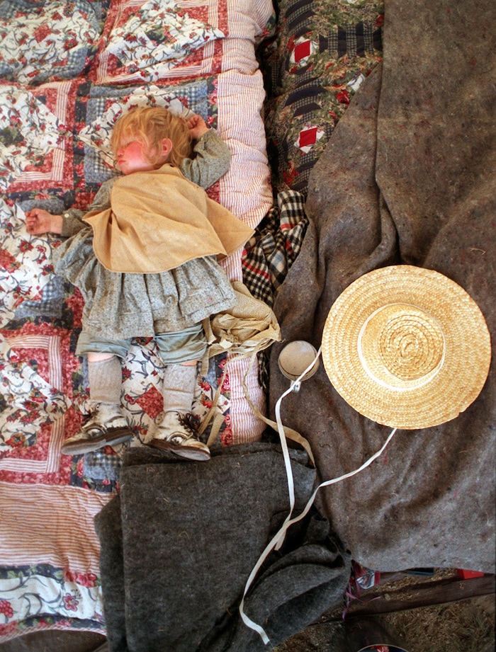 Rick Egan  | Tribune File Photo 

Sixteen-month-old Sarah DeMann takes a nap in a tent in the afternoon at Independence Rock Wyoming.  Sarah and her family took part in the 150 year re-enactment of the Mormons trek across the plains in 1847. 