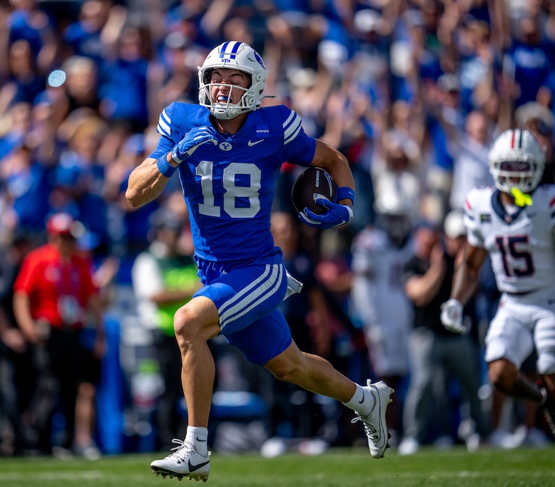 (Trent Nelson  |  The Salt Lake Tribune) BYU Cougars wide receiver Reggie Frischknecht (18) runs for a touchdown as BYU hosts Arizona, NCAA football in Provo on Saturday, Sept. 12, 2026.