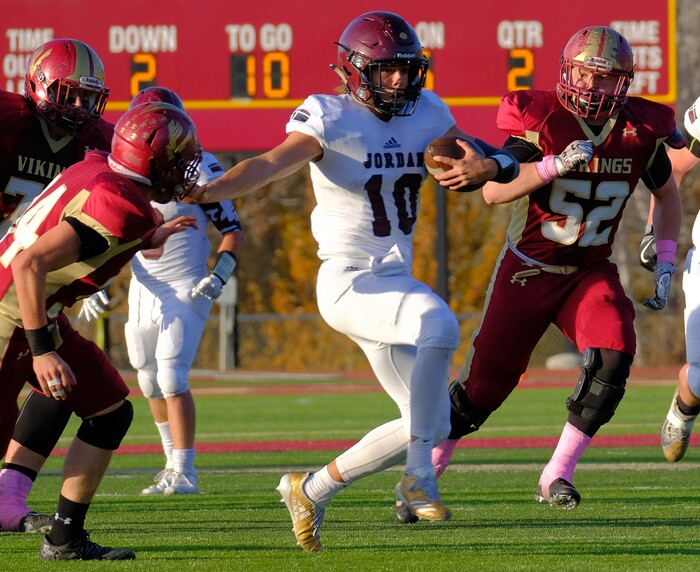 (Leah Hogsten  |  The Salt Lake Tribune) Jordan's  quarterback Crew Wakeley runs for a first down. Jordan High School boys' football team defeated Viewmont High School 28-20 during their class 5A football playoff opener, Friday, October 27, 2017 in Bountiful.