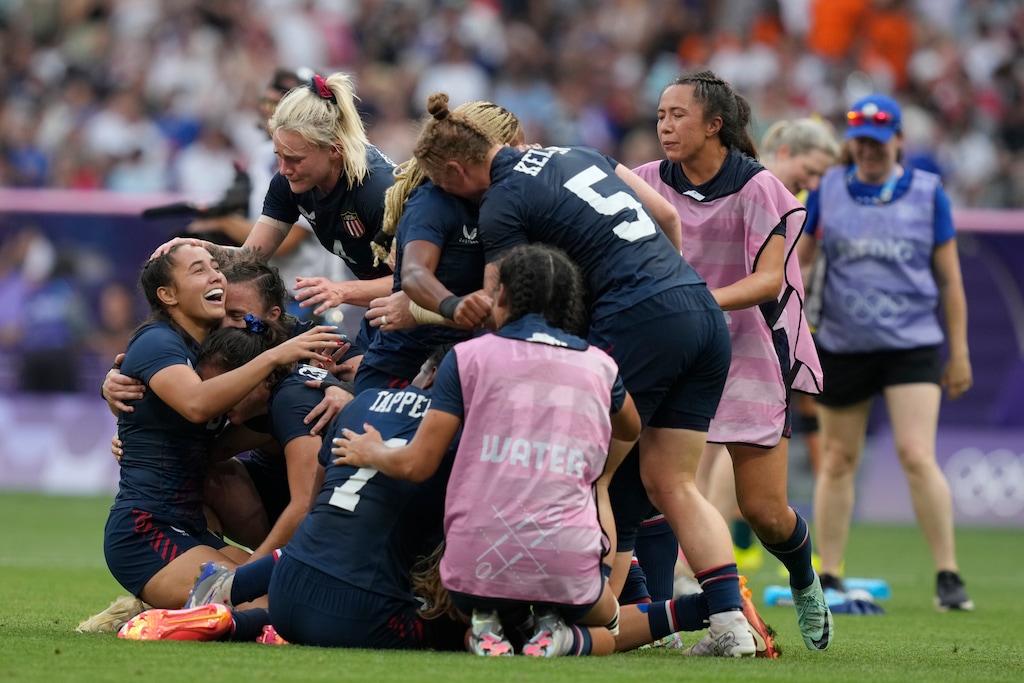 (Vadim Ghirda | AP) The United States team including Alex Sedrick, left, celebrate after winning the women's bronze medal Rugby Sevens match between the United States and Australia at the 2024 Summer Olympics, in the Stade de France, in Saint-Denis, France, Tuesday, July 30, 2024. The US won the game 14-12.