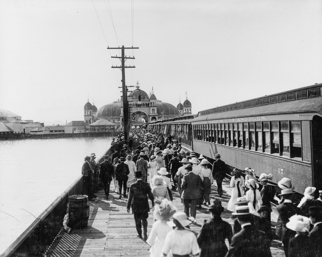 (Utah State Historical Society) Crowds unload from Salt Lake & Los Angeles train to celebrate Independence Day at Saltair, July 4th, 1913. From 1893-1925, the main attractions of the resort were dining, swimming, live music from big music names of the time like Glenn Miller and dancing on reportedly the largest dance floor in the world at that time. 