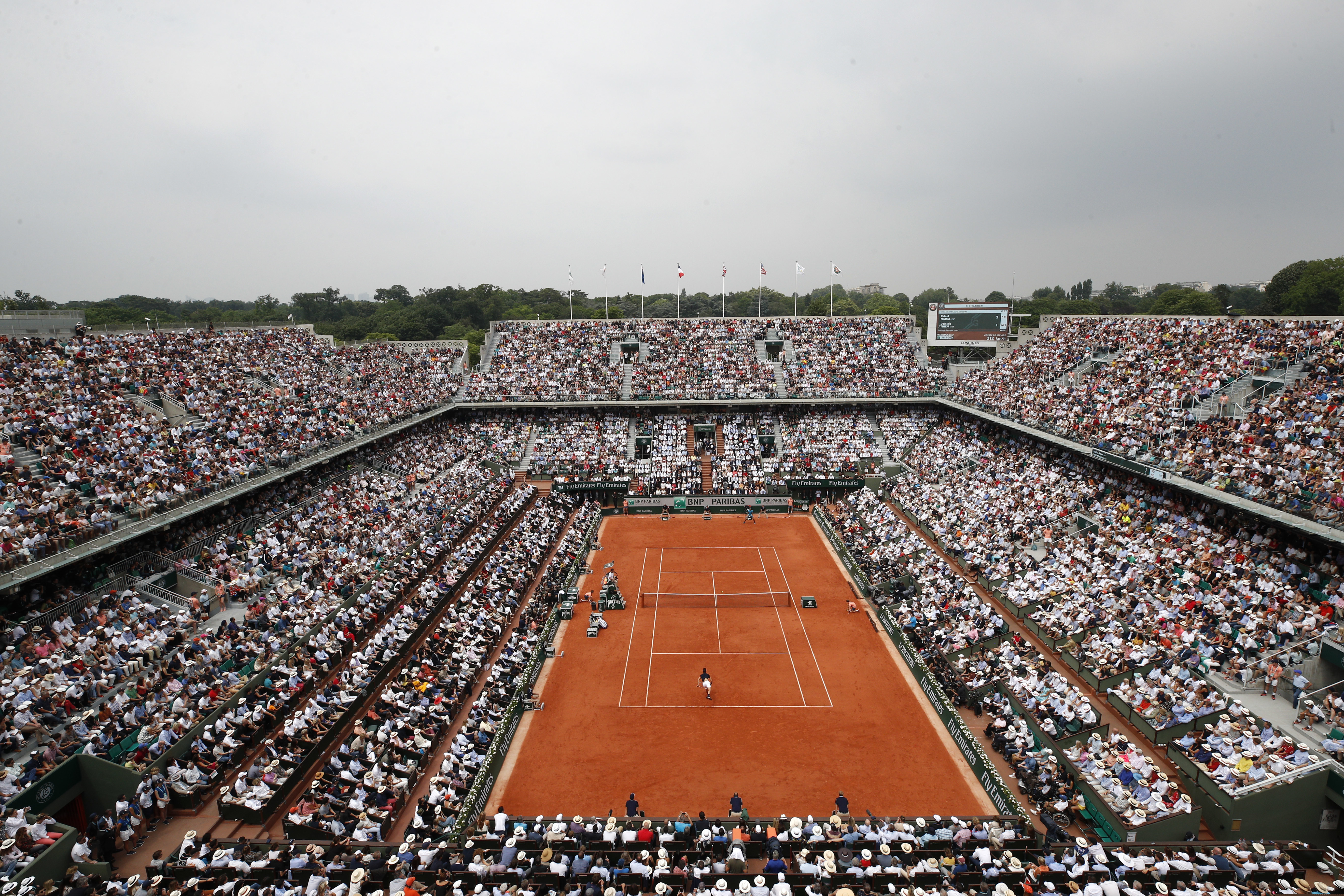 (Christophe Ena | AP file photo) In this June 10, 2018 file photo, the crowd watches Austria's Dominic Thiem serving to Spain's Rafael Nadal during the men's final match of the French Open tennis tournament at the Roland Garros stadium in Paris. Spectators will be allowed at the French Open later this month despite the growing number of coronavirus cases in the country, organizers said on Monday as they unveiled the health protocols for the clay-court Grand Slam tournament. The event will take place at Roland Garros stadium in western Paris from Sept. 27 after being postponed from its May date due to the pandemic.