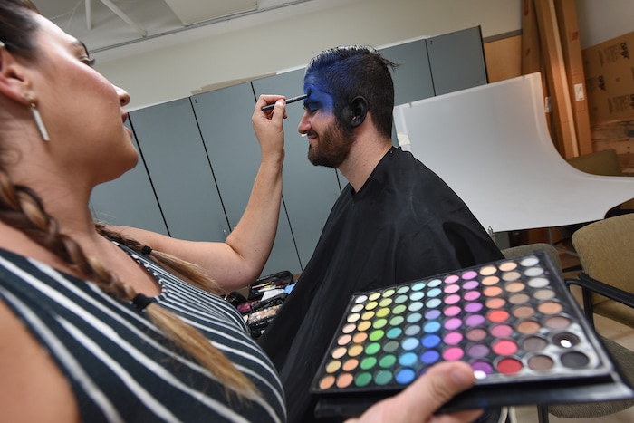 (Francisco Kjolseth | The Salt Lake Tribune) Makeup artist Kristen Packard works her magic on Brad Klekas of South Jordan, a BYU and Utah fan alike as he's willing to show his mutual admiration of both teams by stepping into the Tribune studio to get both colors in anticipation of the upcoming match up between the two rival teams on Saturday.