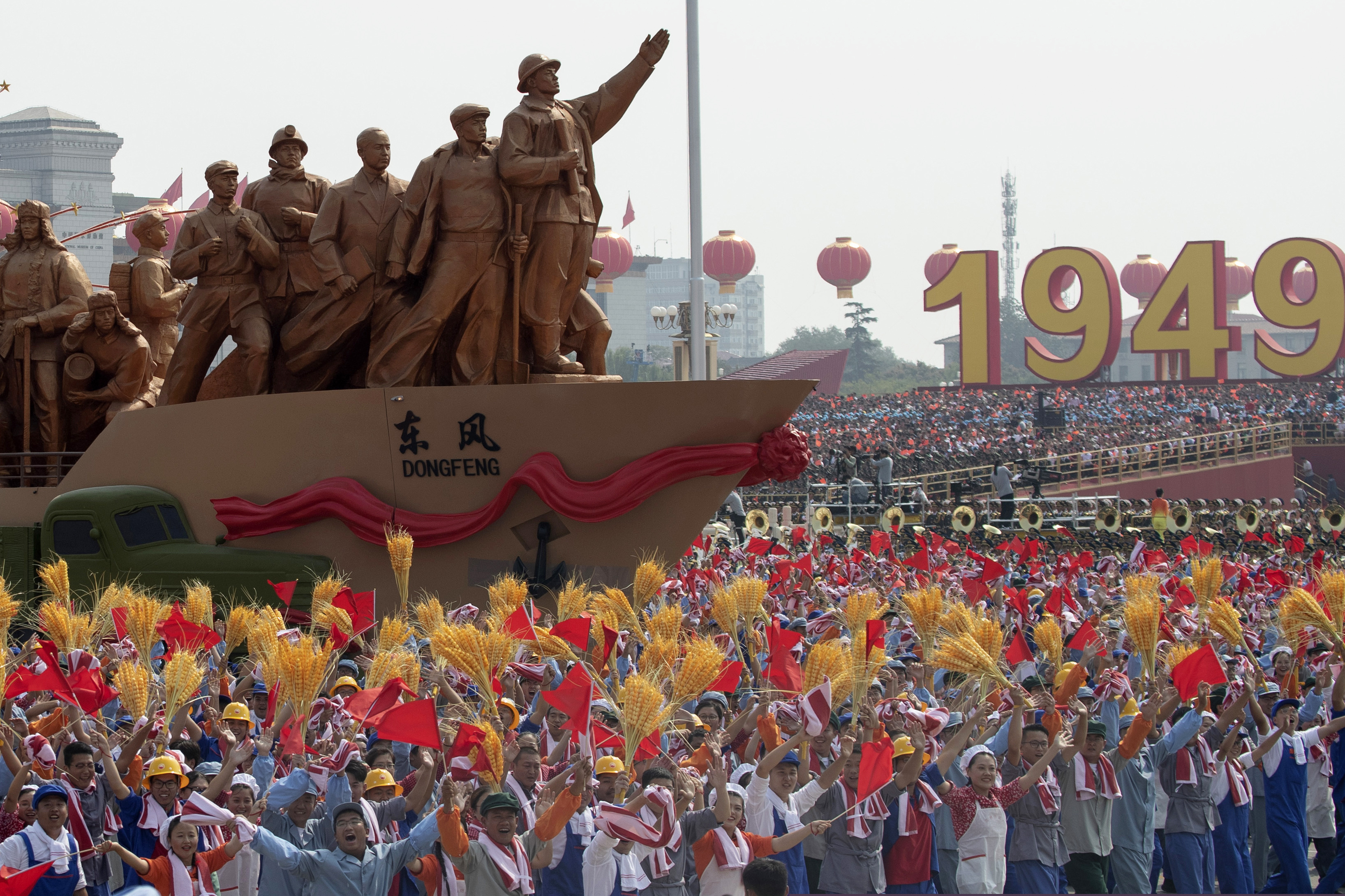 (Ng Han Guan | AP) Performers dance at a parade for the 70th anniversary of the founding of the People's Republic of China in Beijing on Tuesday, Oct. 1, 2019. A colorful parade with 70 floats and 100,000 participants highlighting communist China's achievements is following a military parade in Beijing on the 70th anniversary of Communist Party rule.