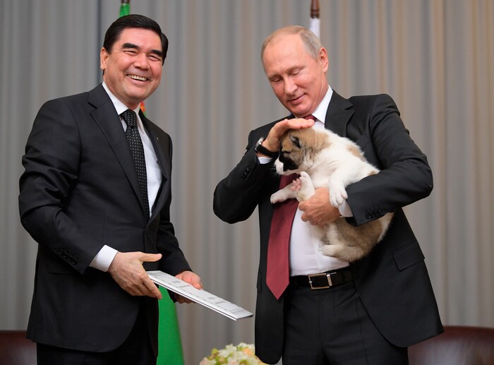 Turkmenistan's President Gurbanguly Berdymukhamedov, right, smiles as he presents a puppy to Russian President Vladimir Putin during their meeting in the Bocharov Ruchei residence in the Black Sea resort of Sochi, Russia, Wednesday, Oct. 11, 2017. The presidents met on the sidelines of a summit of leaders of ex-Soviet nations in Sochi. (Alexei Druzhinin/Sputnik, Kremlin Pool Photo via AP)