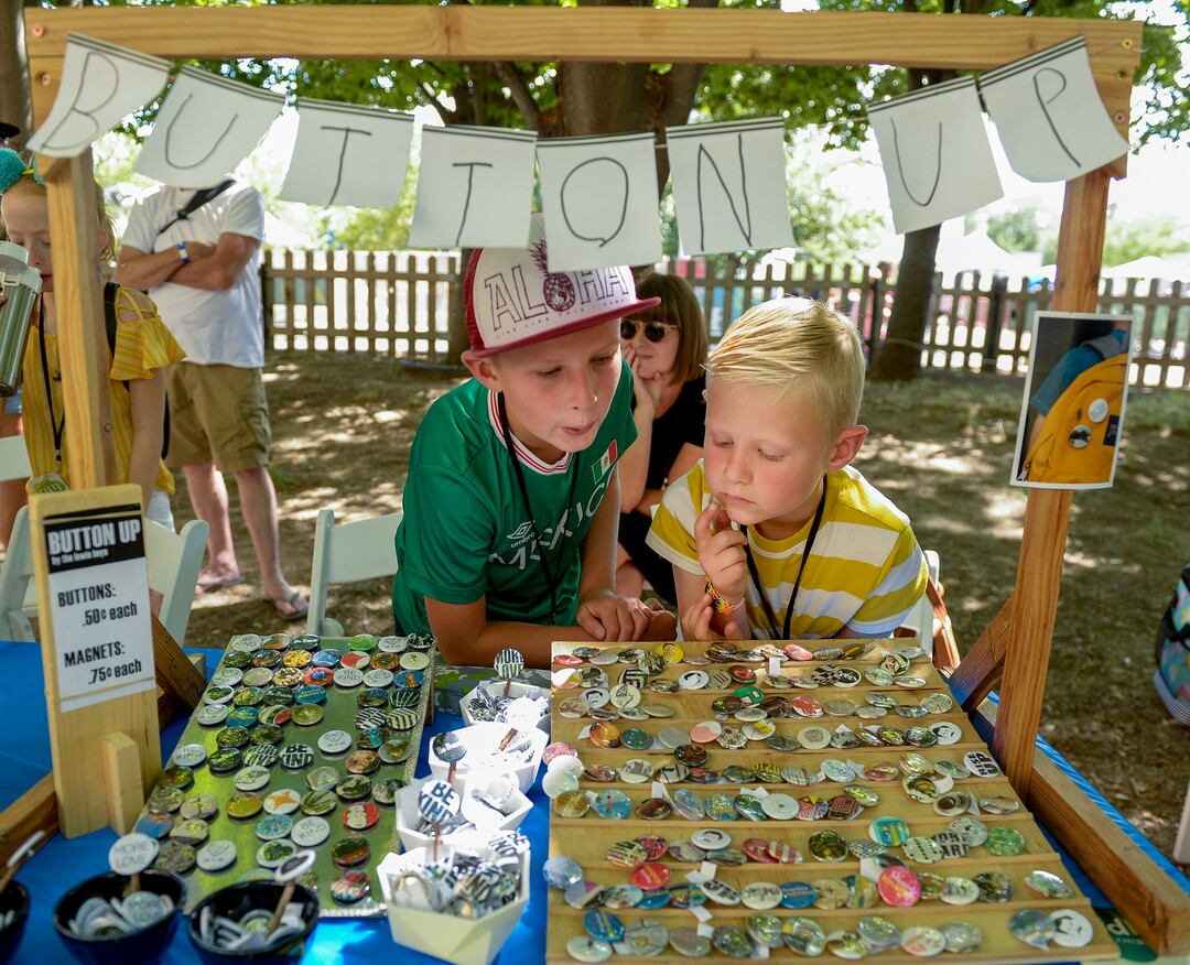 (Leah Hogsten  |  The Salt Lake Tribune)  l-r Brothers Simon Lewis, 9, and Elliot Lewis, 7, sell art buttons at their Button Up booth with the mother, Lisa Lewis behind them at the Craft Lake City DIY Festival Kid Row, where children 14 and under make and sell their products. Craft Lake CityÕs DIY Festival is UtahÕs largest local, three day arts festival with over 300 artisans, DIY engineers, vintage vendors and craft food creators.