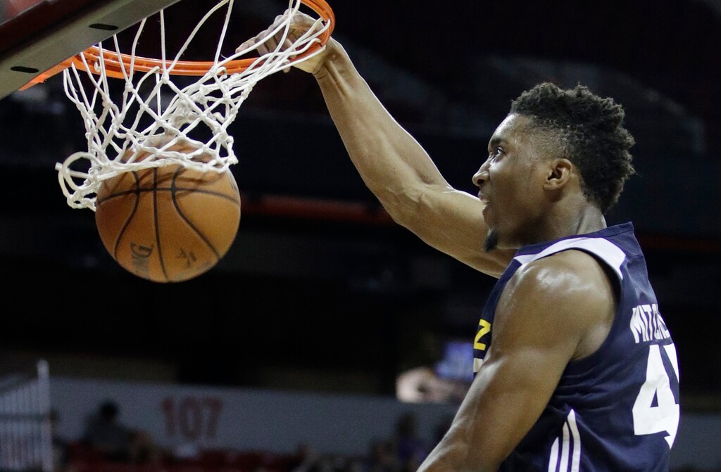 Utah Jazz's Donovan Mitchell dunks against the Memphis Grizzlies during the second half of an NBA summer league basketball game, Tuesday, July 11, 2017, in Las Vegas. (AP Photo/John Locher)