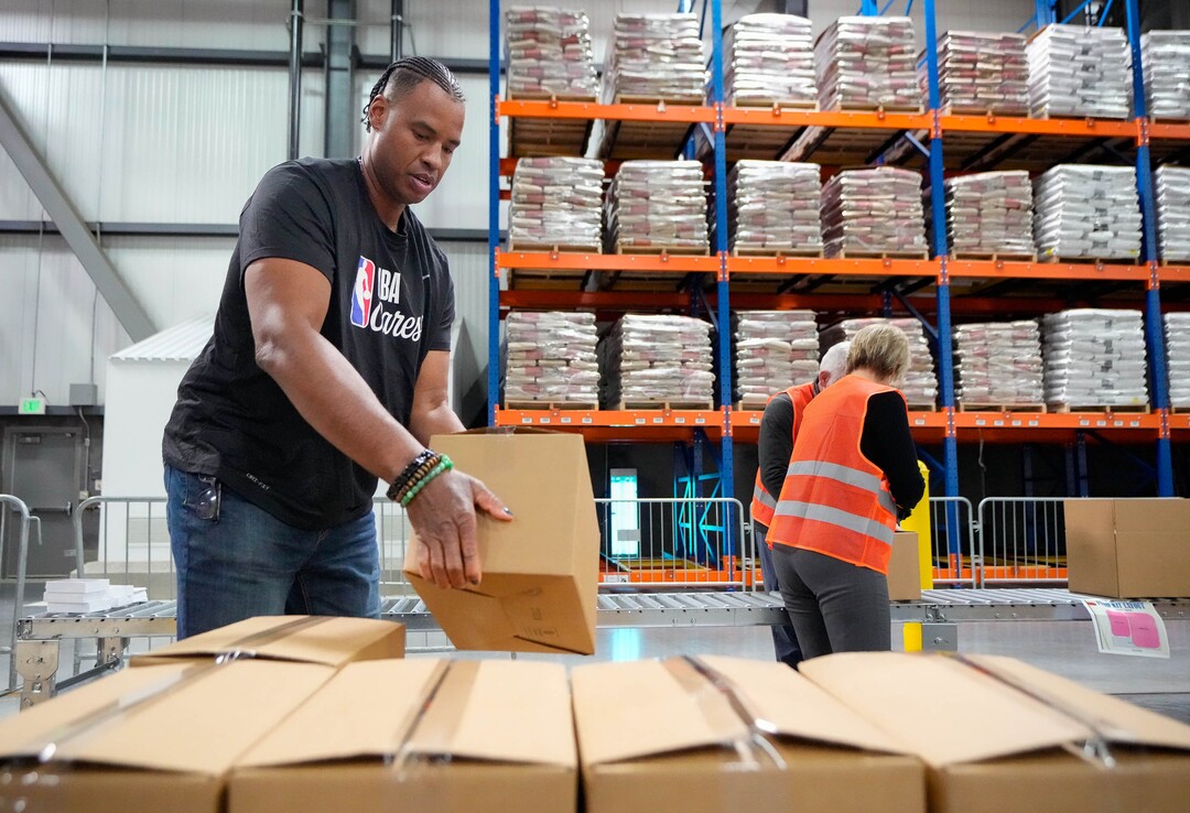 (Francisco Kjolseth | The Salt Lake Tribune) Jason Collins, a community ambassador for NBA Cares, joins other NBA volunteers as they help pack food boxes as part of hands-on service projects focused on alleviating food insecurity at Bishop’s Central Storehouse in Salt Lake City on Friday, Feb. 17, 2023.