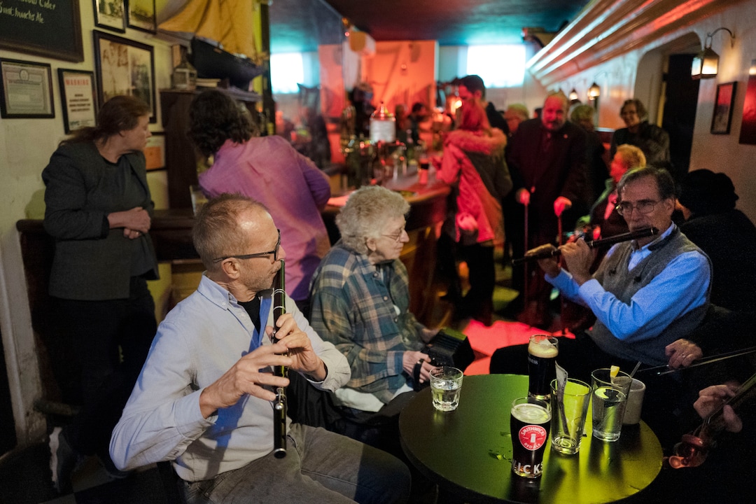In this Dec. 31, 2019 photo, Richard Heitzman joins with fellow musicians to perform traditional Irish tunes in New York's William Barnacle Tavern, once a speakeasy during Prohibition. Americans are consuming more alcohol per capita now than in the time leading up to Prohibition, when alcohol opponents successfully made the case that excessive drinking was ruining family life. (AP Photo/Mark Lennihan)